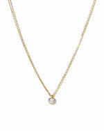 Gold Tiny Bezel Pendant Necklace from Sami Jewels, close-up view showing delicate chain and small bezel pendant on a white background.