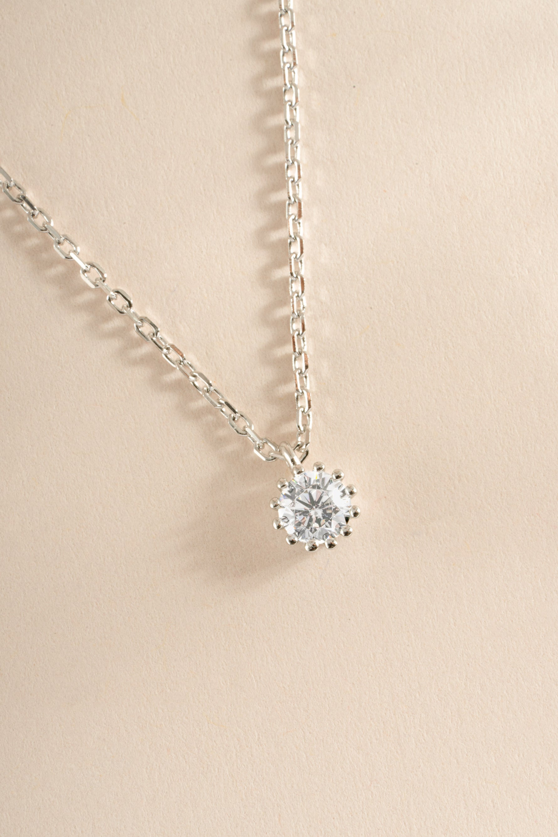 Close-up of Sami Jewels tiny bezel pendant necklace in sterling silver, showcasing the delicate pendant design.