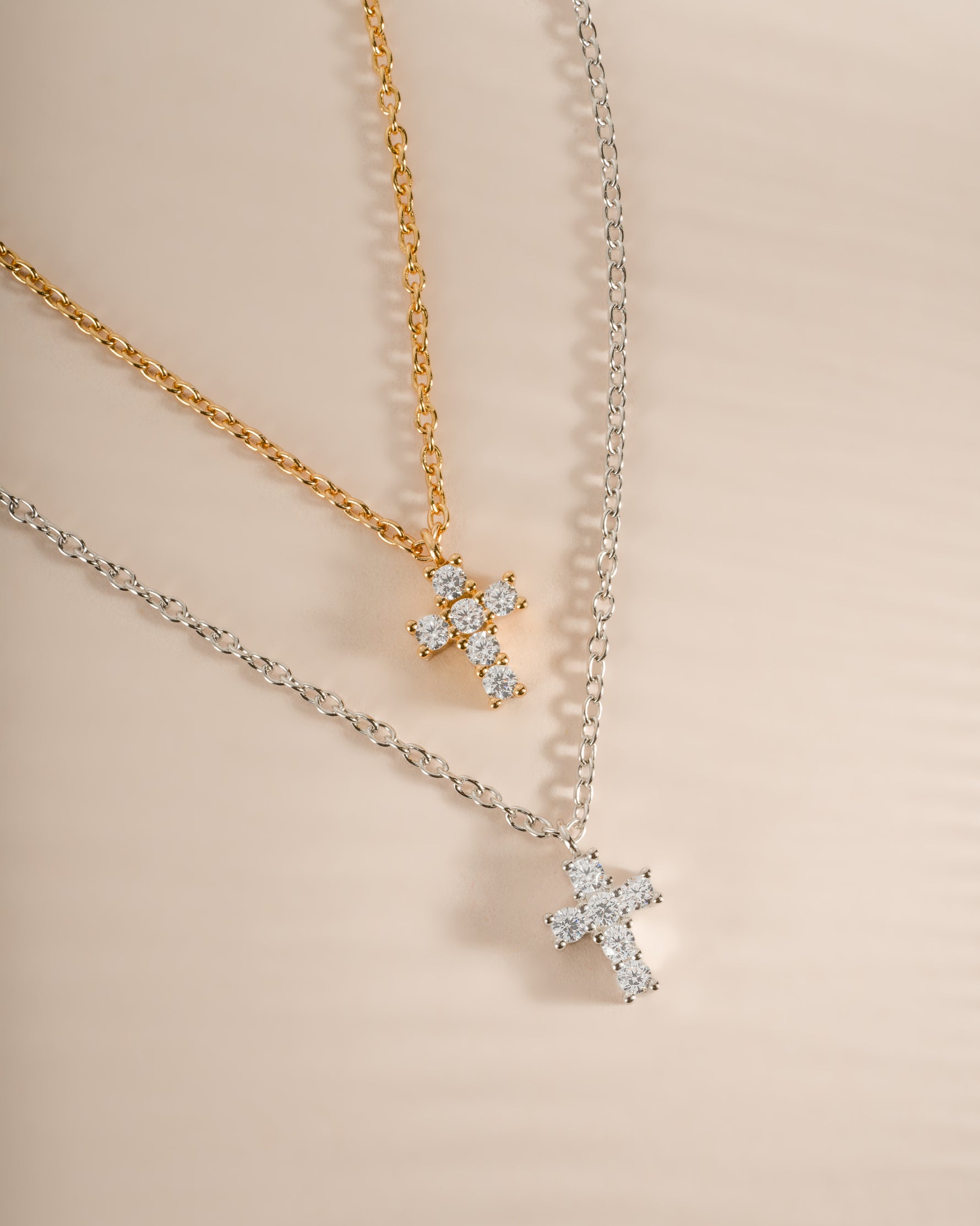 Sterling silver and gold tiny cross pendant necklace from Sami Jewels, featuring a delicate and minimalist design.
