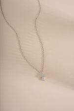 Sterling silver Tiny Cross Necklace pendant from Sami Jewels, featuring a delicate cross design on a fine chain.