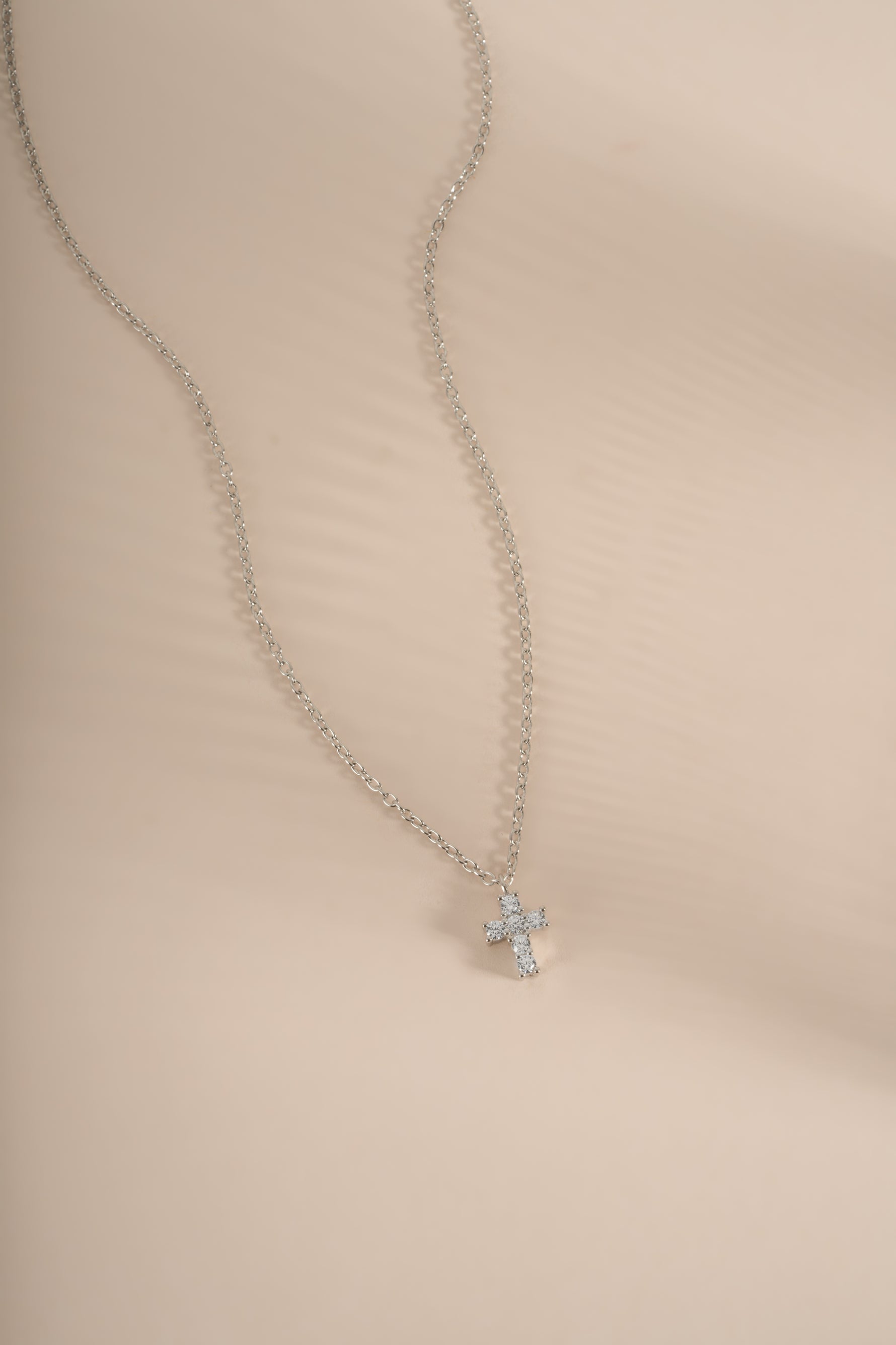 Sterling silver Tiny Cross Necklace pendant from Sami Jewels, featuring a delicate cross design on a fine chain.