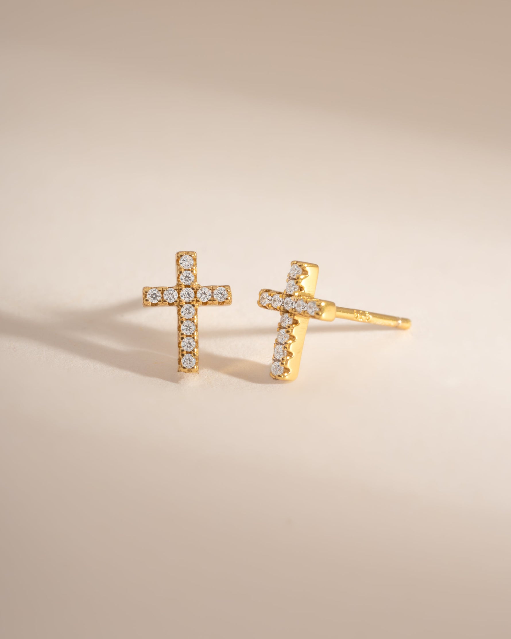 Gold Tiny Cross Stud Earrings by Sami Jewels, angled view showing small cross design and stud backing.