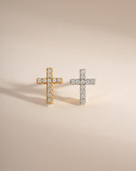 Sterling silver and gold tiny cross stud earrings by Sami Jewels displayed on a white background.