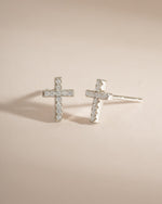 Sterling silver tiny cross stud earrings by Sami Jewels featuring minimalist religious design and secure post-back closures.