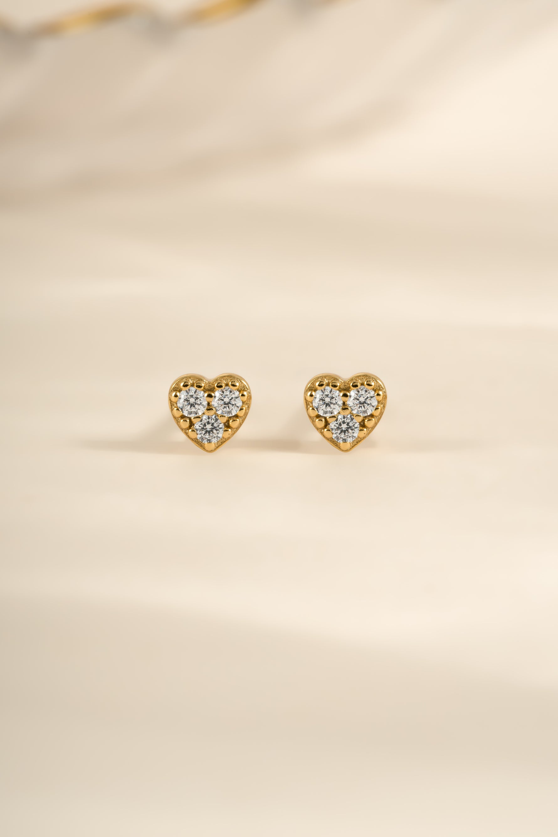 Gold Tiny Heart CZ Stud Earrings by Sami Jewels, front view showing small heart-shaped cubic zirconia studs.