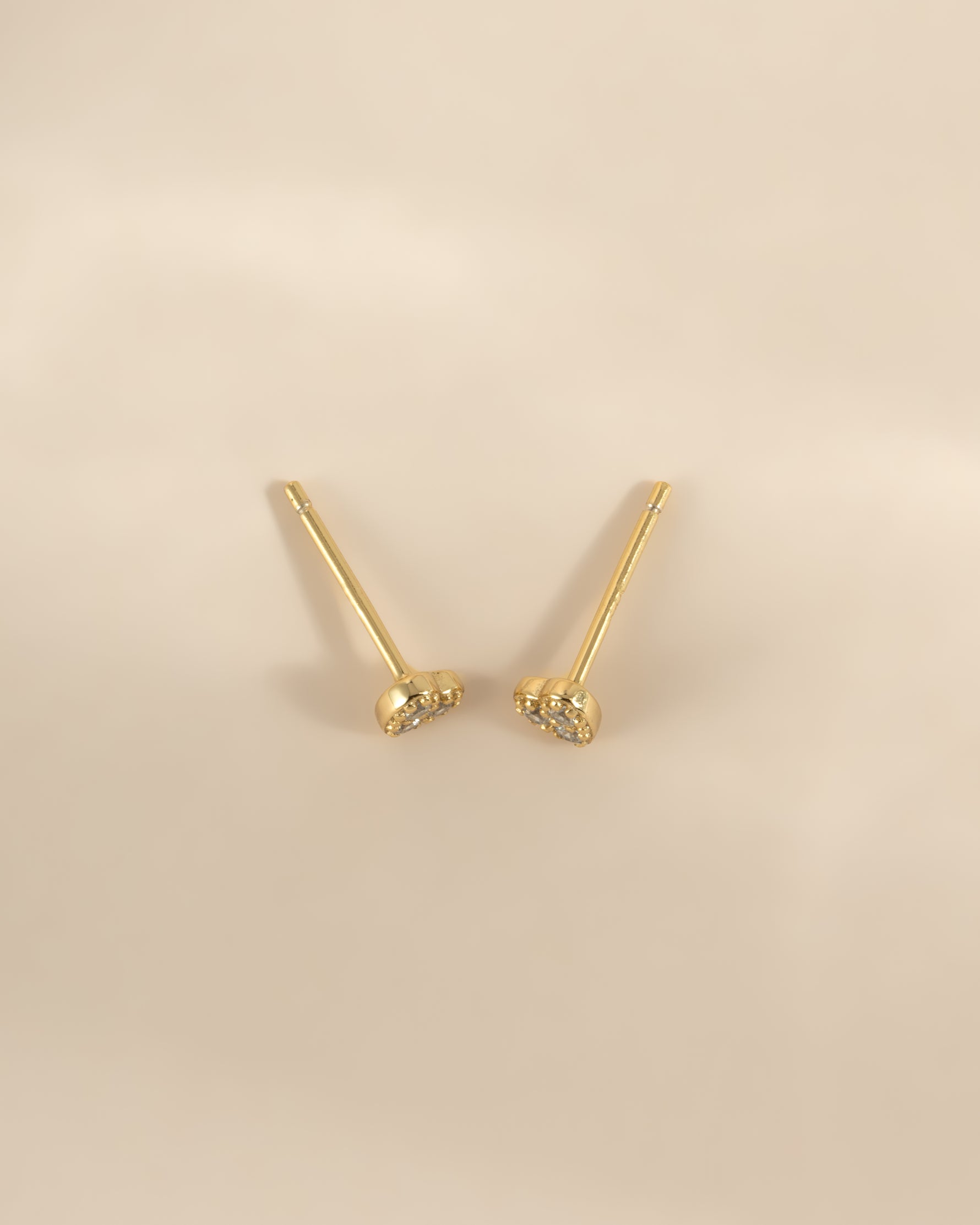 Gold Tiny Heart CZ Stud Earrings by Sami Jewels, small heart-shaped sparkling cubic zirconia studs viewed from above.