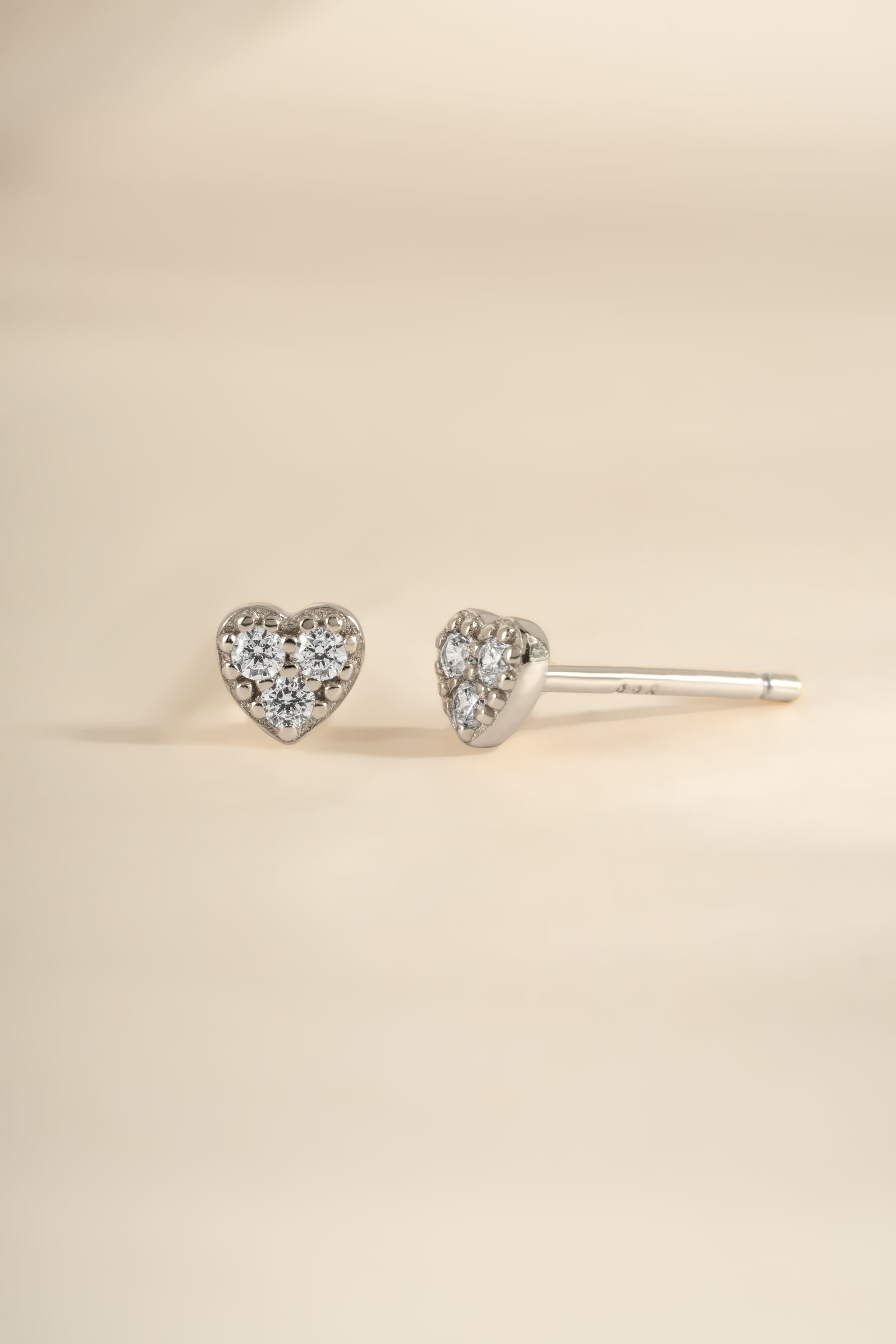Sterling silver Tiny Heart CZ Stud Earrings by Sami Jewels featuring sparkling cubic zirconia heart-shaped design.