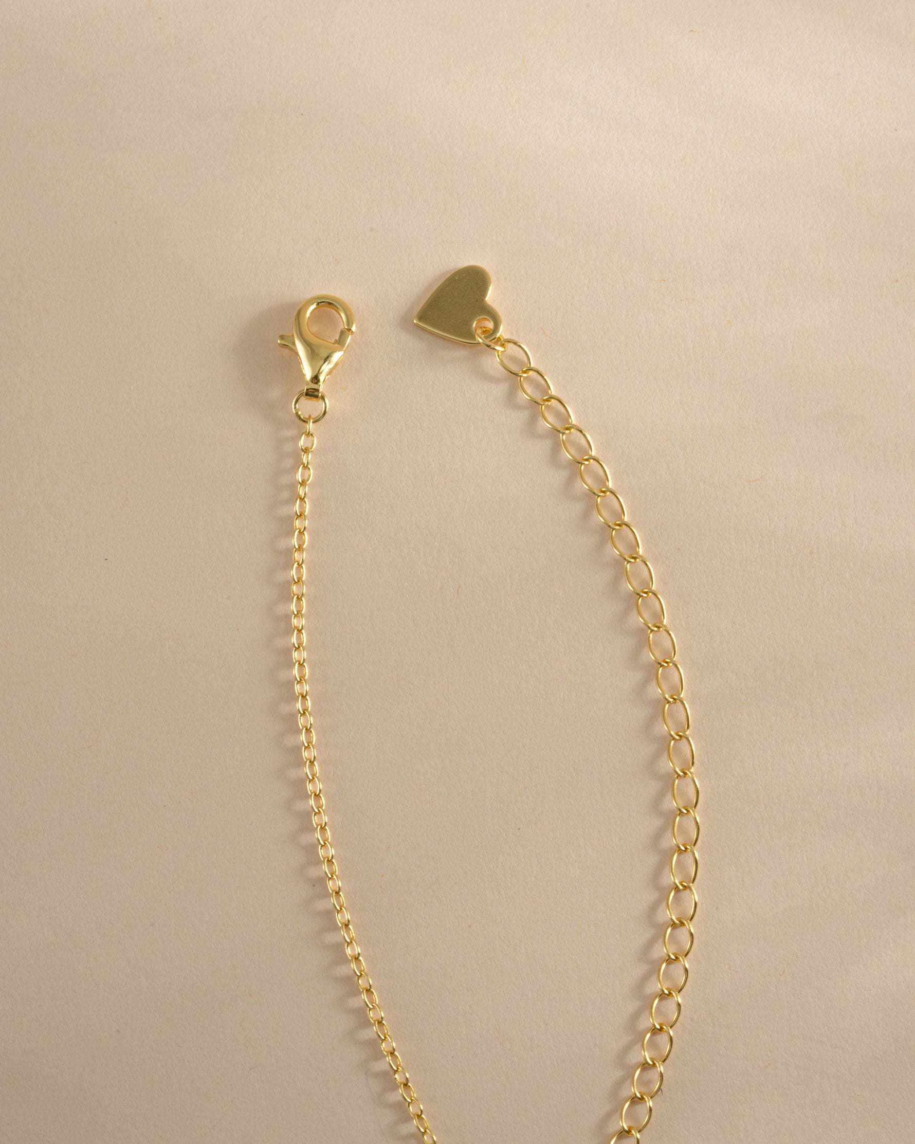 Gold Tiny Evil Eye Necklace from Sami Jewels with lobster clasp closure, featuring a small evil eye pendant on a delicate chain.