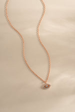 Rose gold tiny evil eye necklace from Sami Jewels featuring a delicate charm on a fine chain.