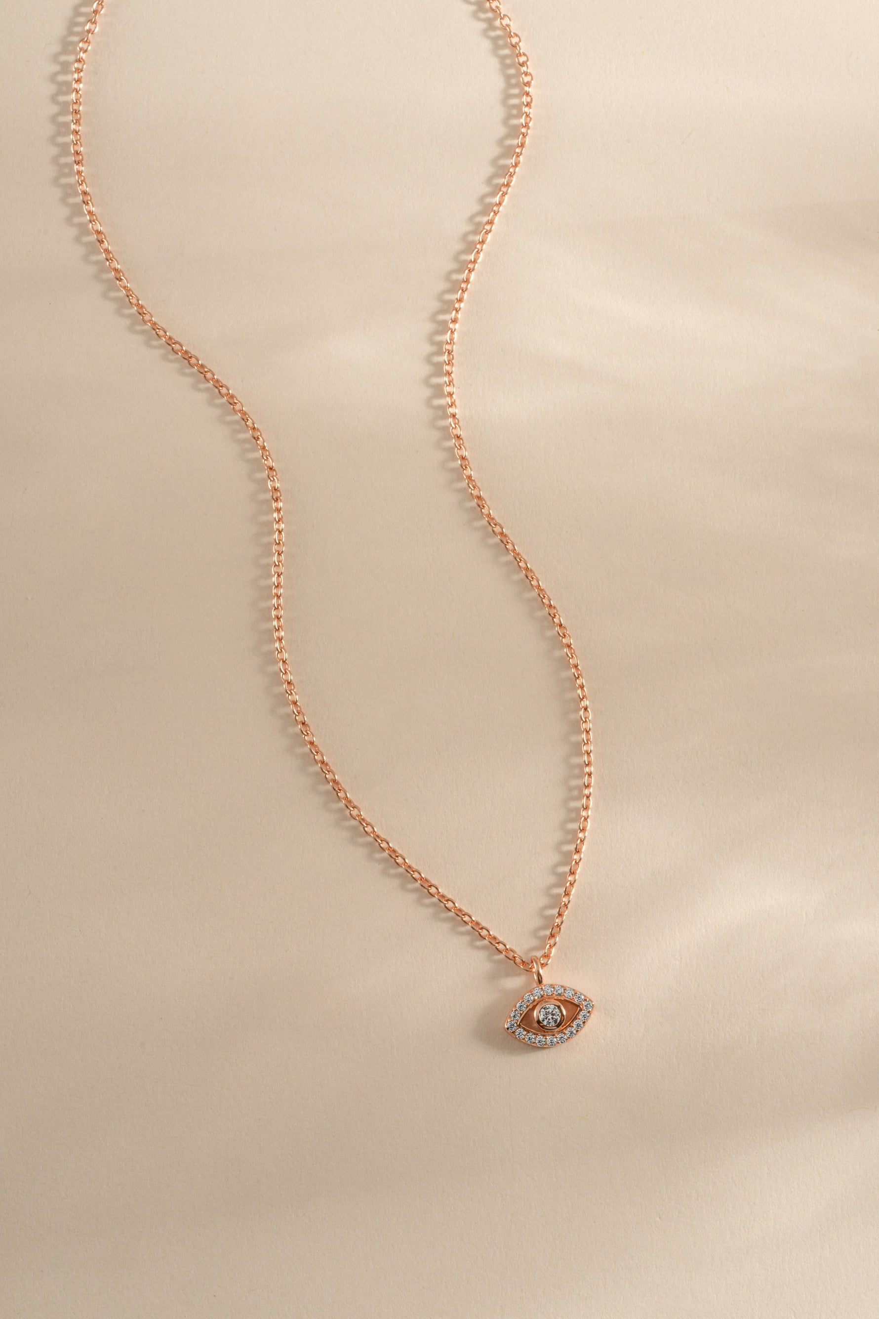 Rose gold tiny evil eye necklace from Sami Jewels featuring a delicate charm on a fine chain.
