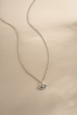 Sterling silver tiny evil eye necklace from Sami Jewels, featuring a delicate charm on a fine chain.