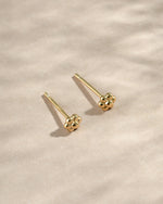 Gold tiny flower stud earrings from Sami Jewels, top view showing delicate floral design and small size.