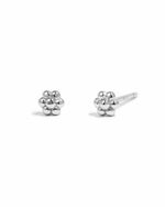 Sterling silver tiny flower stud earrings by Sami Jewels on a white background. Small, delicate flower design perfect for everyday wear.