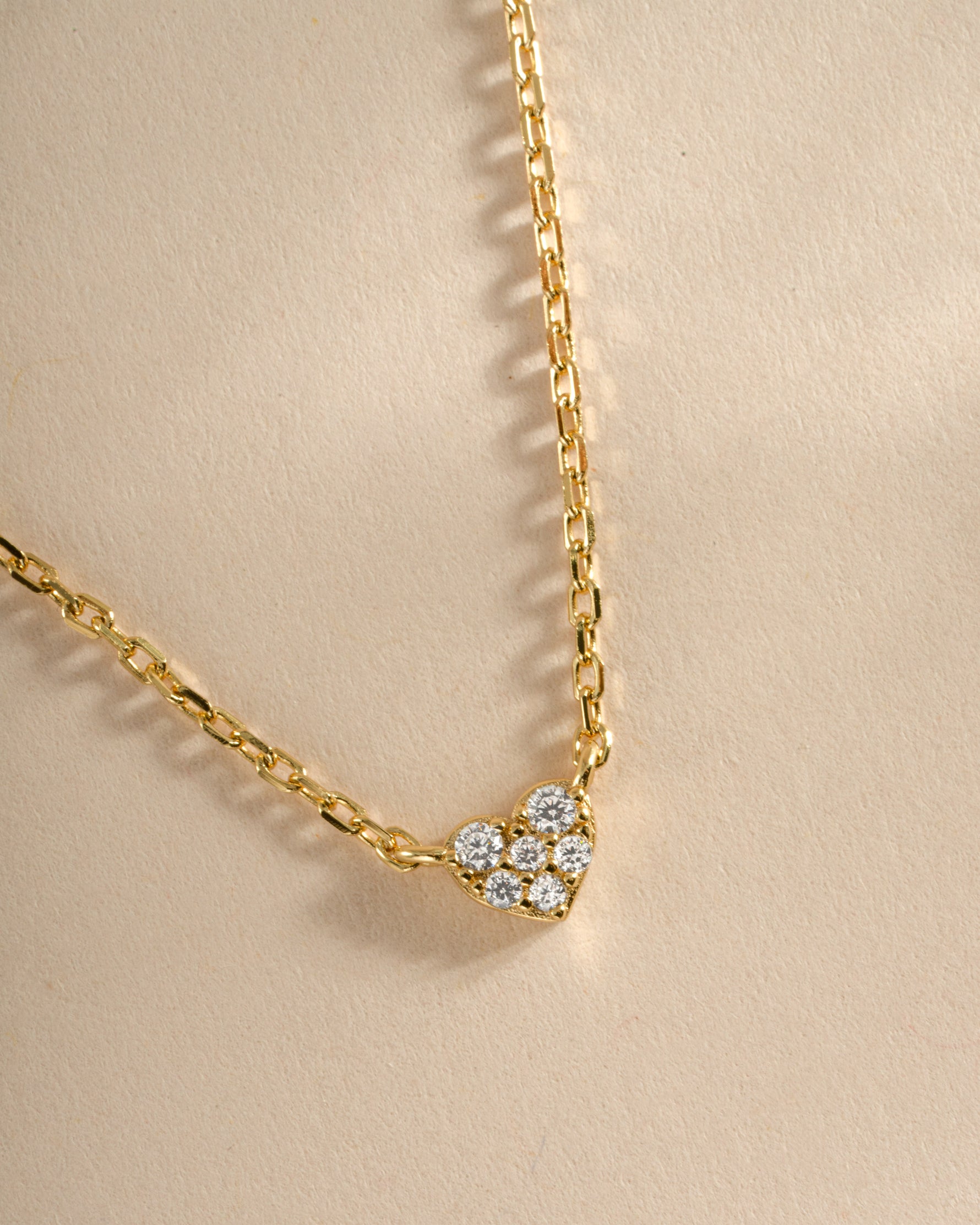 Close-up of Sami Jewels' gold tiny heart necklace showing delicate chain and small heart pendant.