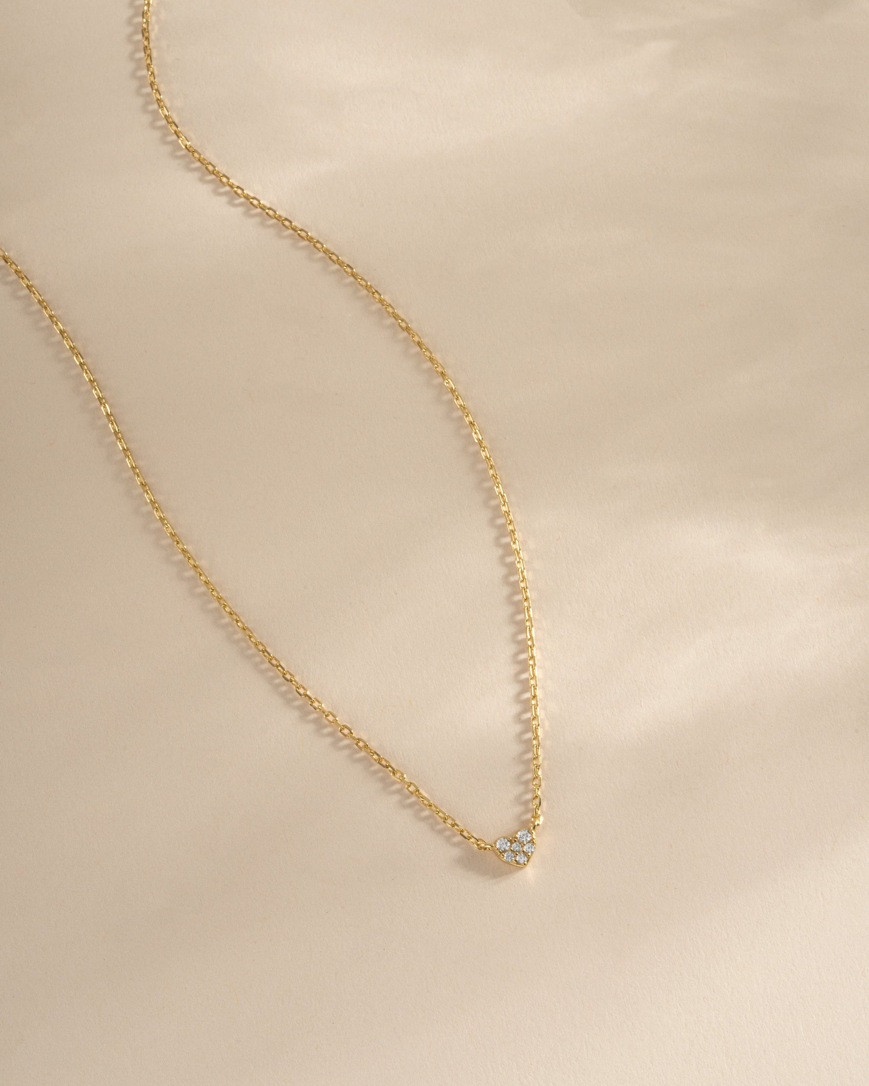 Gold Tiny Heart Necklace from Sami Jewels featuring a delicate heart pendant on a fine chain.
