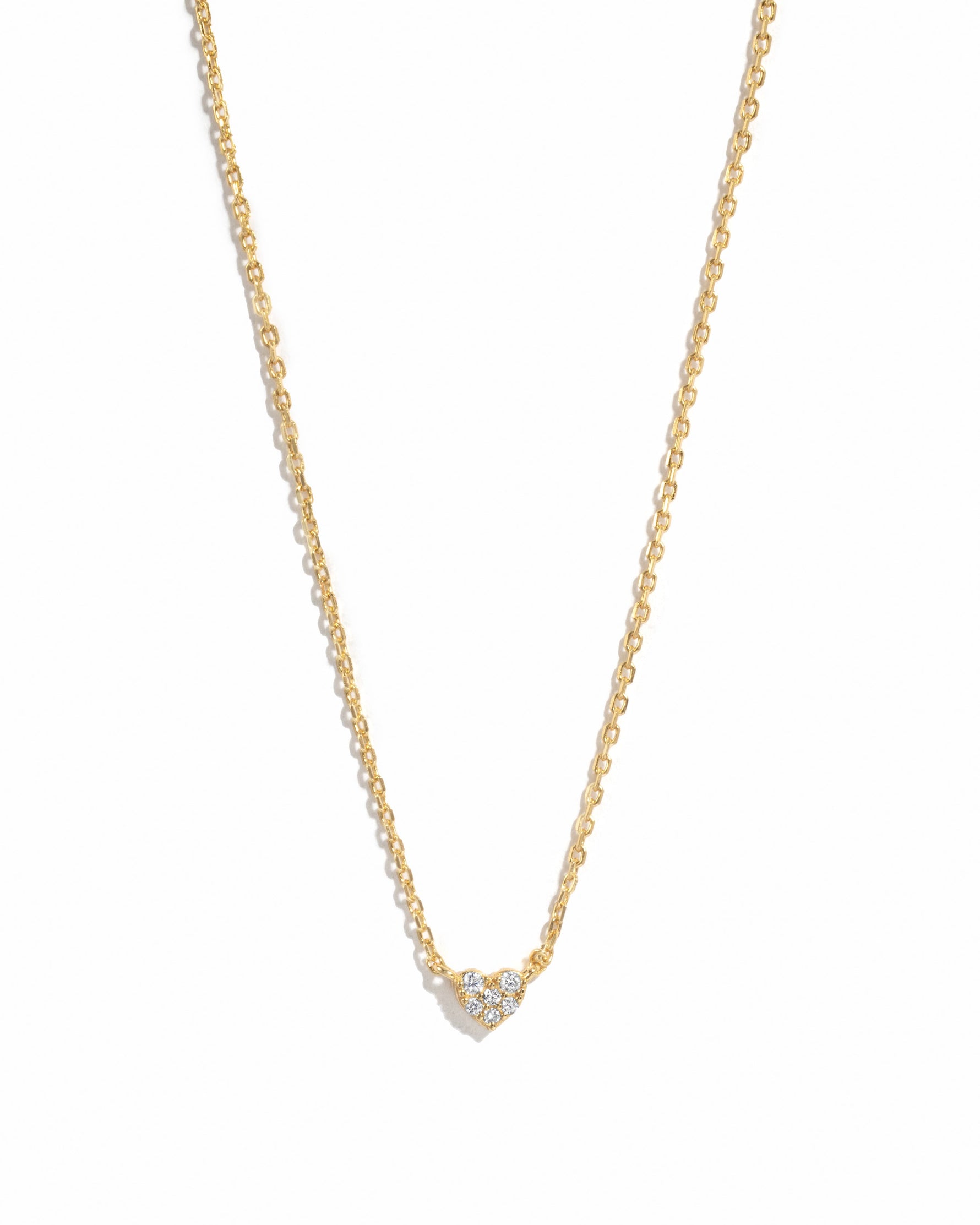 Gold Tiny Heart Necklace by Sami Jewels, delicate jewelry with a small heart pendant on a white background.