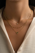 Gold Tiny Heart Necklace from Sami Jewels featuring a delicate heart pendant on a fine chain.