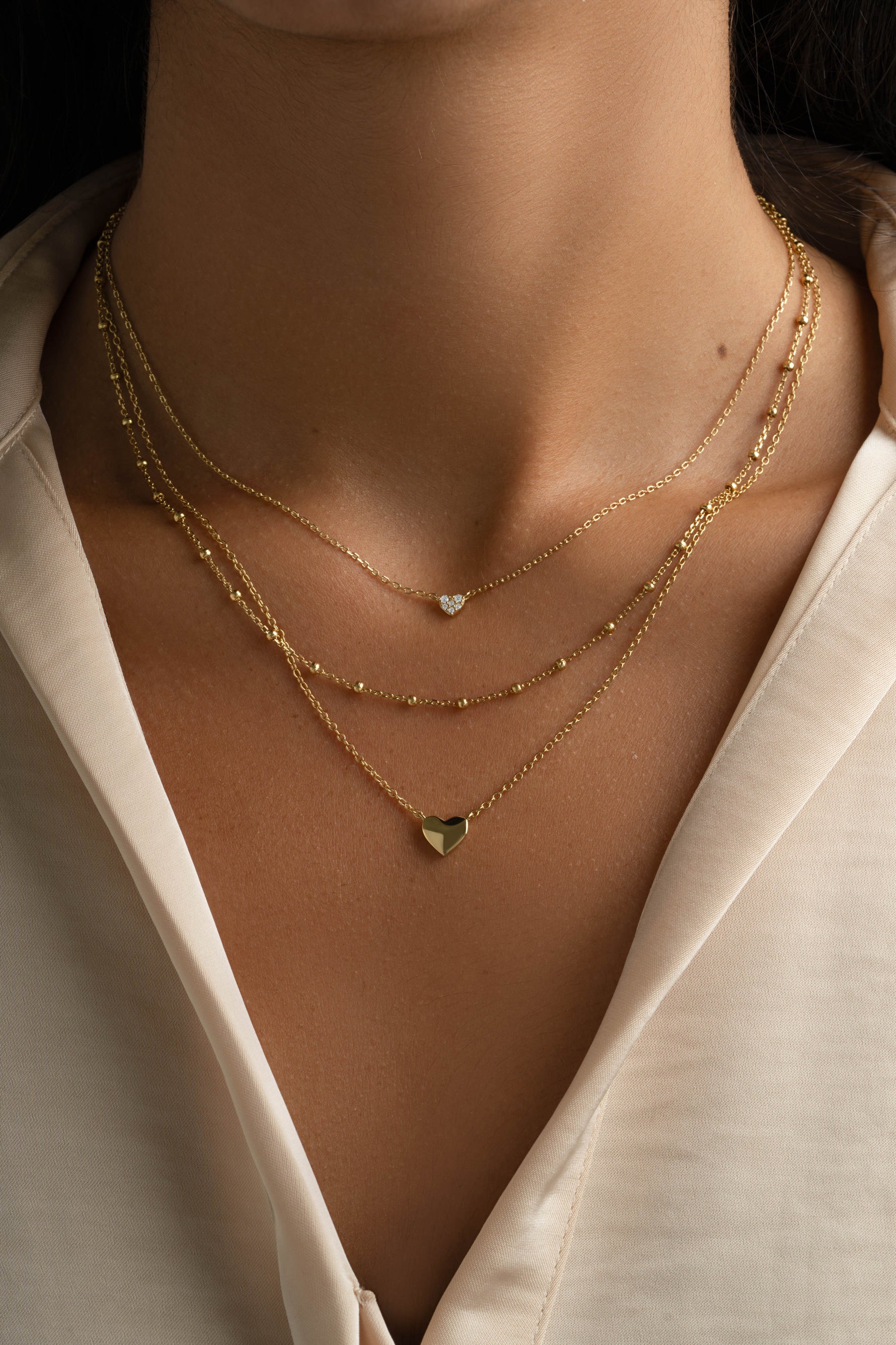 Gold Tiny Heart Necklace from Sami Jewels featuring a delicate heart pendant on a fine chain.