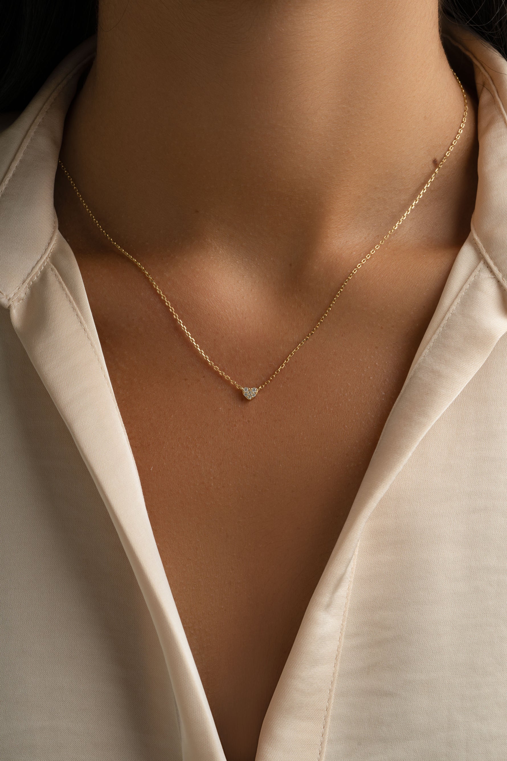 Gold Tiny Heart Necklace by Sami Jewels featuring a delicate heart pendant on a fine chain.