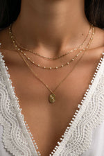 Gold Tiny Link Paperclip Necklace by Sami Jewels, featuring a sleek paperclip chain design on a model.