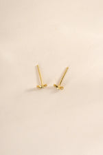 Gold tiny moon stud earrings by Sami Jewels, top view showing small moon-shaped design on each earring