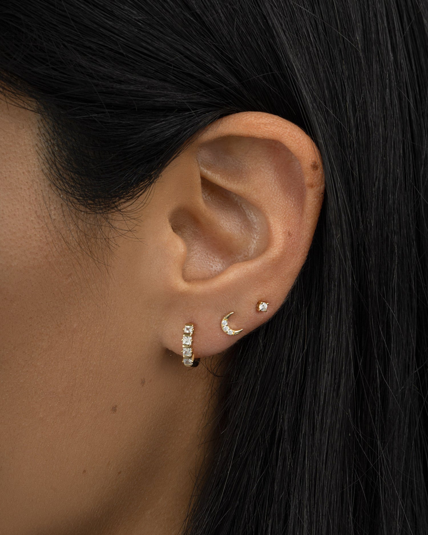 tiny moon stud earring stack in gold on model 
