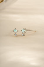 Sterling silver tiny opal stud earrings by Sami Jewels featuring small, iridescent gemstone studs on classic earring posts
