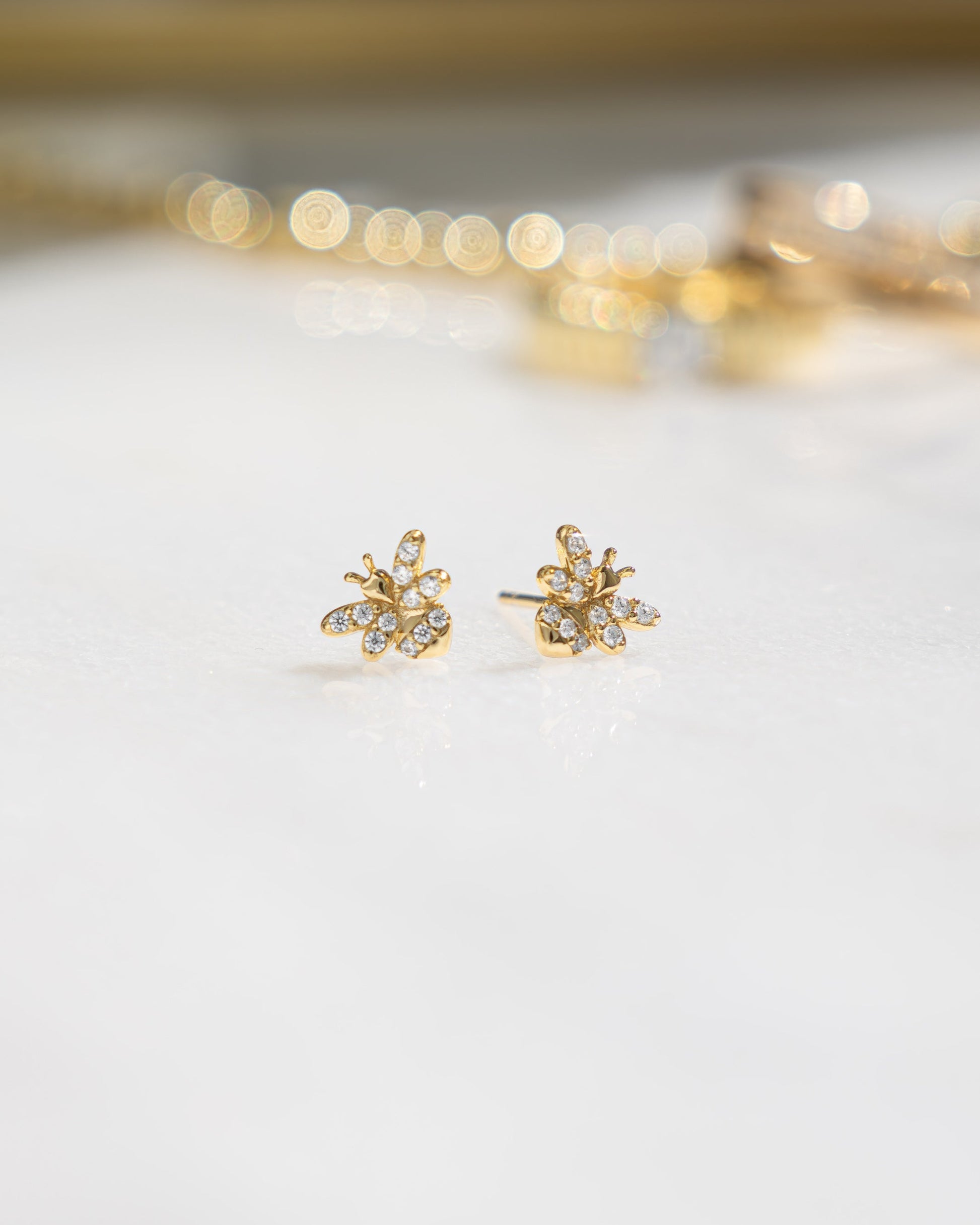 closeup image of gold dainty stud earrings 