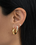 tube hoop earrings in gold in models earring stack