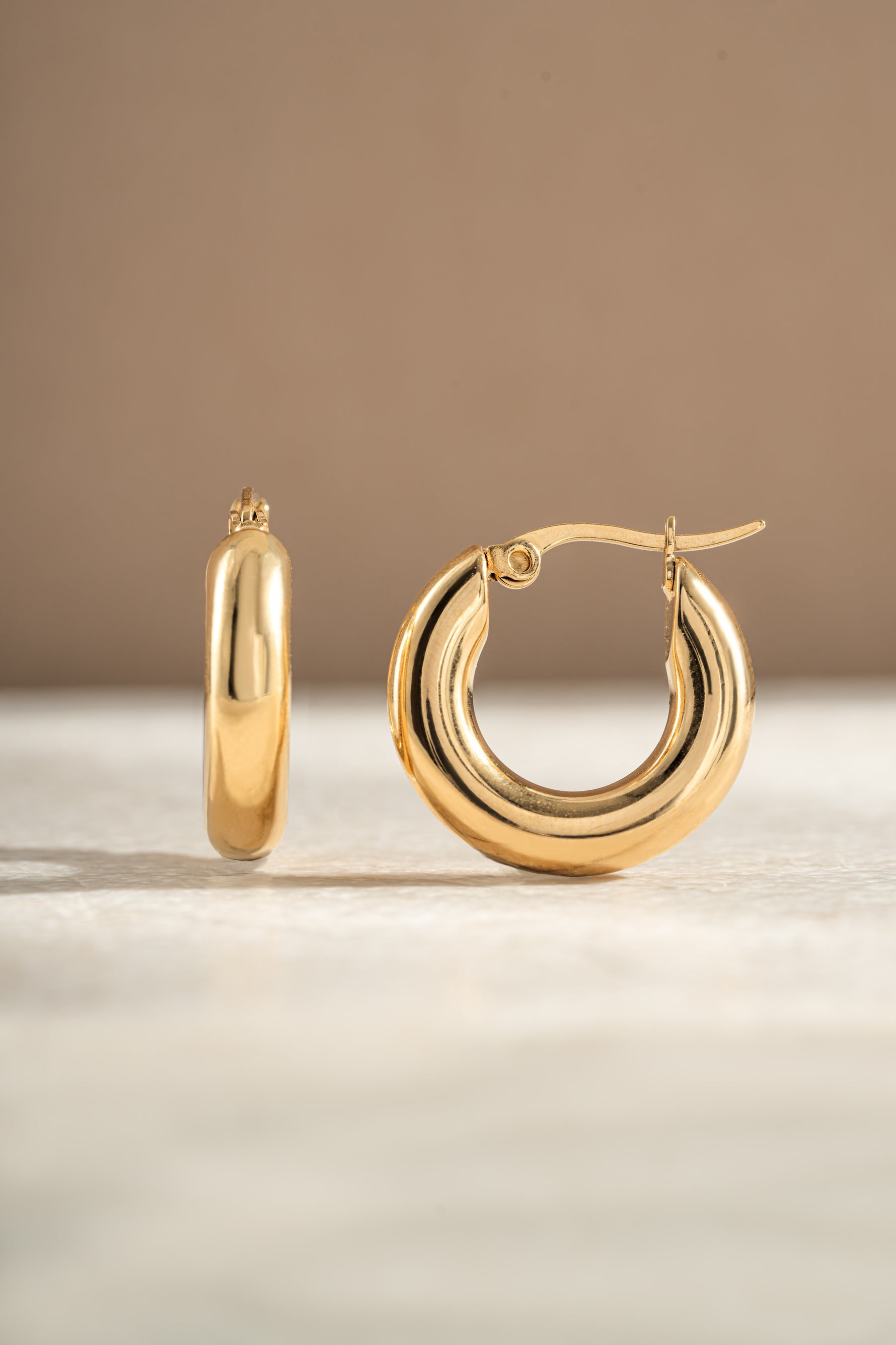 tube hoop earrings in gold side view 