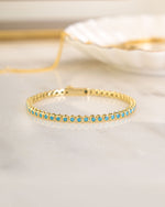 Turquoise bezel tennis bracelet by Sami Jewels featuring gold setting and elegant design, perfect for jewelry collection.