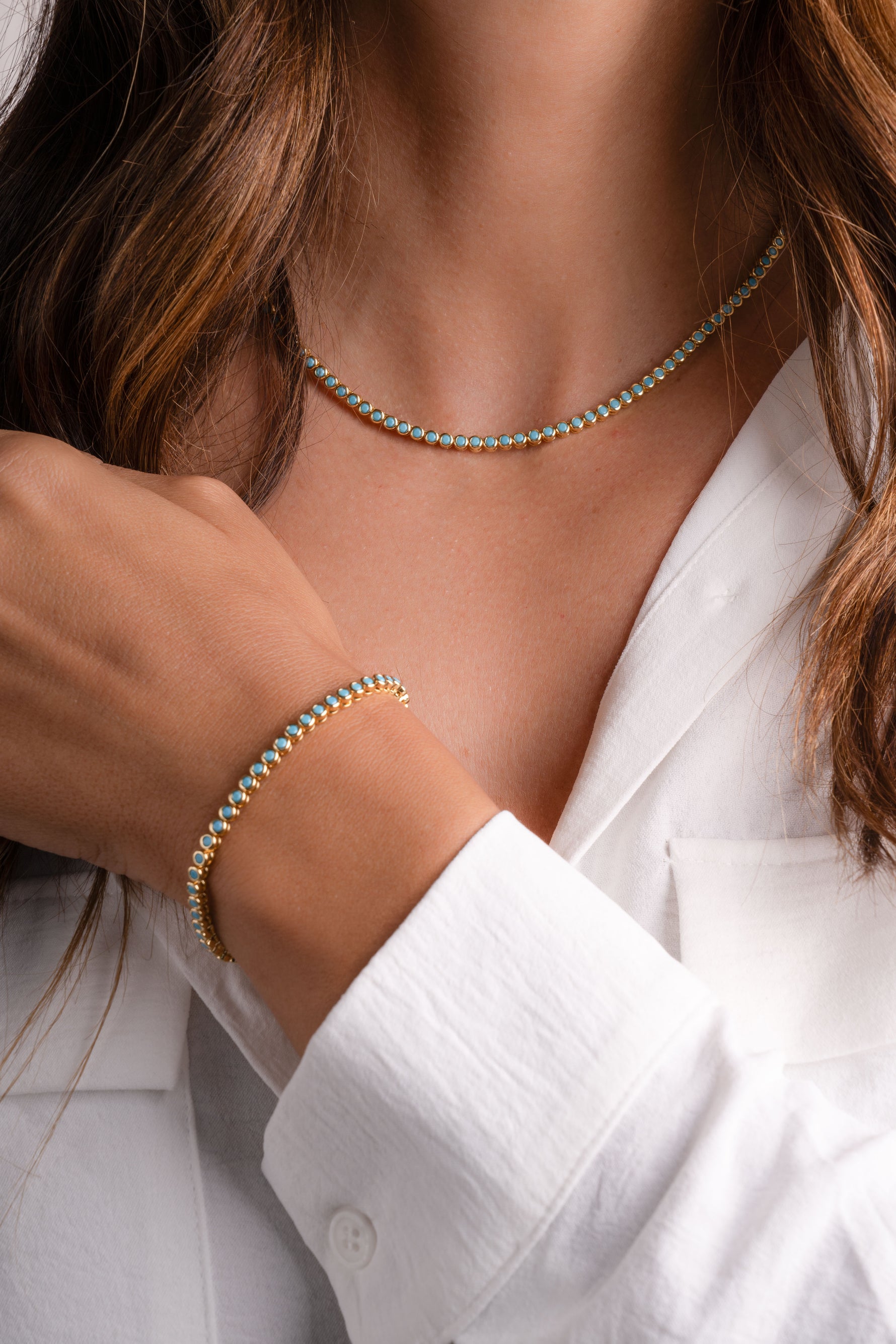 Turquoise bezel tennis jewelry set including necklace and bracelet from Sami Jewels, featuring gold accents and vibrant turquoise stones.