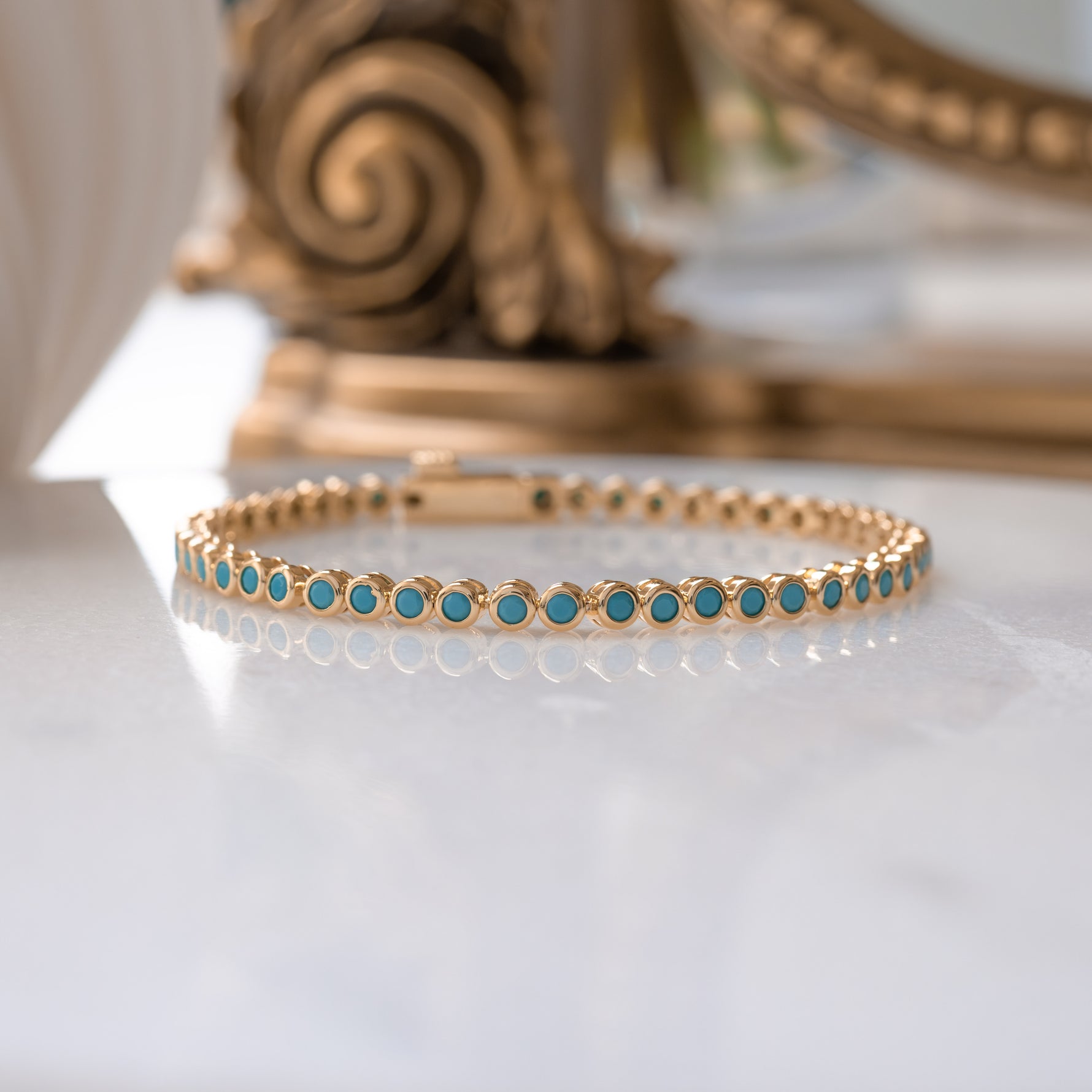 Turquoise bezel tennis bracelet by Sami Jewels featuring a row of turquoise stones set in a sleek metal band.