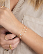 Dainty turquoise beaded bracelet by Sami Jewels with small round beads on a delicate elastic cord.