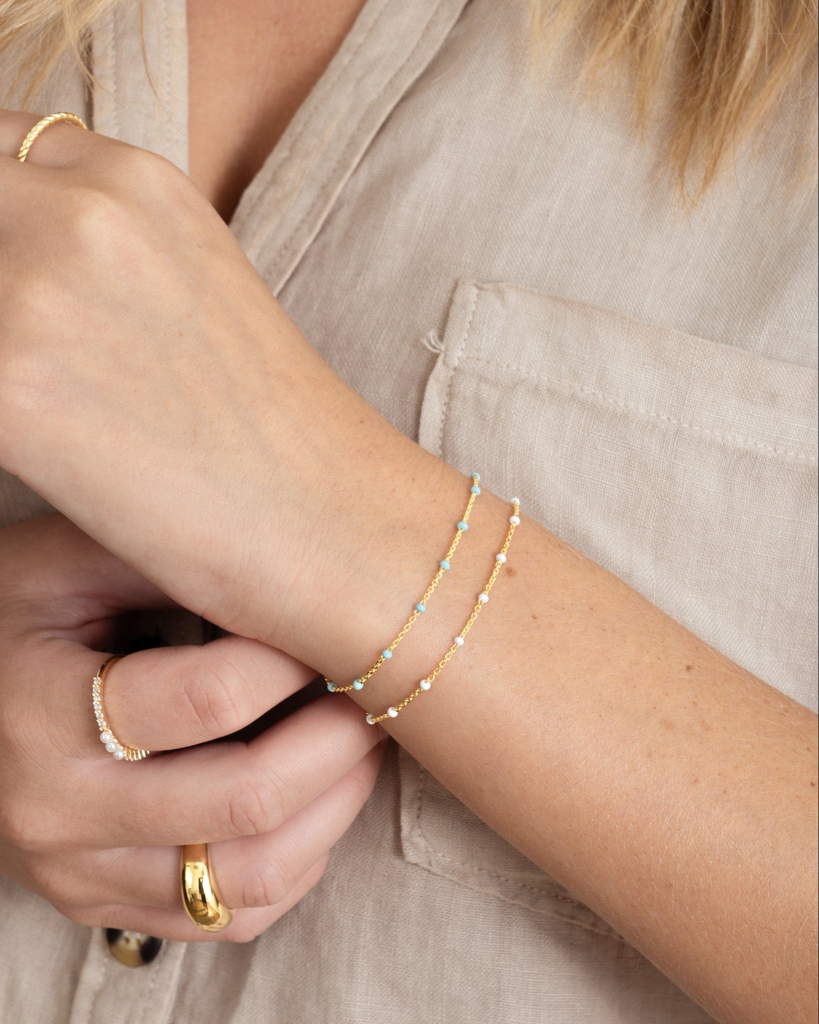 Dainty turquoise beaded bracelet by Sami Jewels with small round beads on a delicate elastic cord.