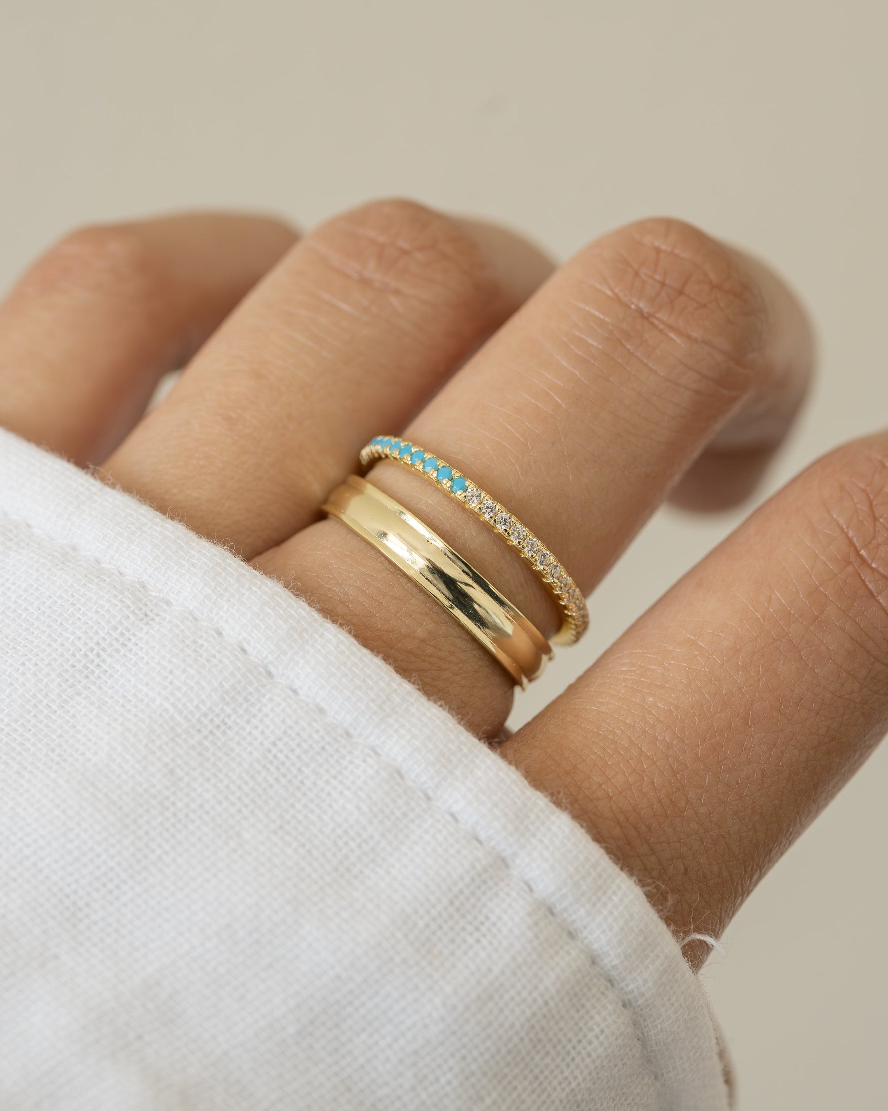 Sami Jewels turquoise and diamond eternity ring with a continuous band of vibrant turquoise stones and sparkling diamonds.