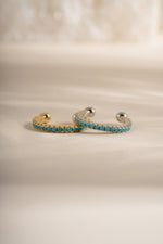 Front view of Sami Jewels turquoise ear cuff earrings featuring gold and sterling silver design.