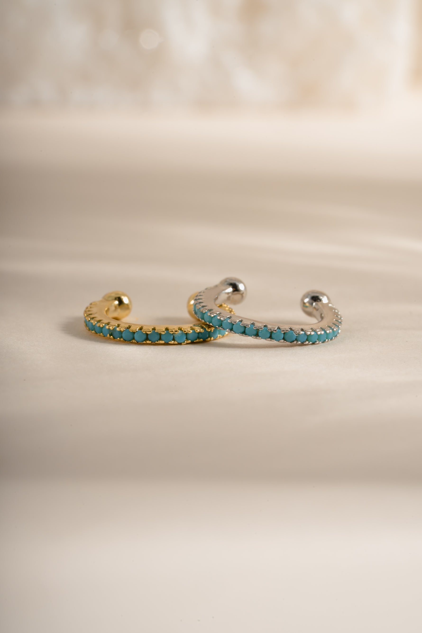 Front view of Sami Jewels turquoise ear cuff earrings featuring gold and sterling silver design.