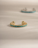 Gold turquoise ear cuff earrings by Sami Jewels, front view showing detailed turquoise stone and elegant design.