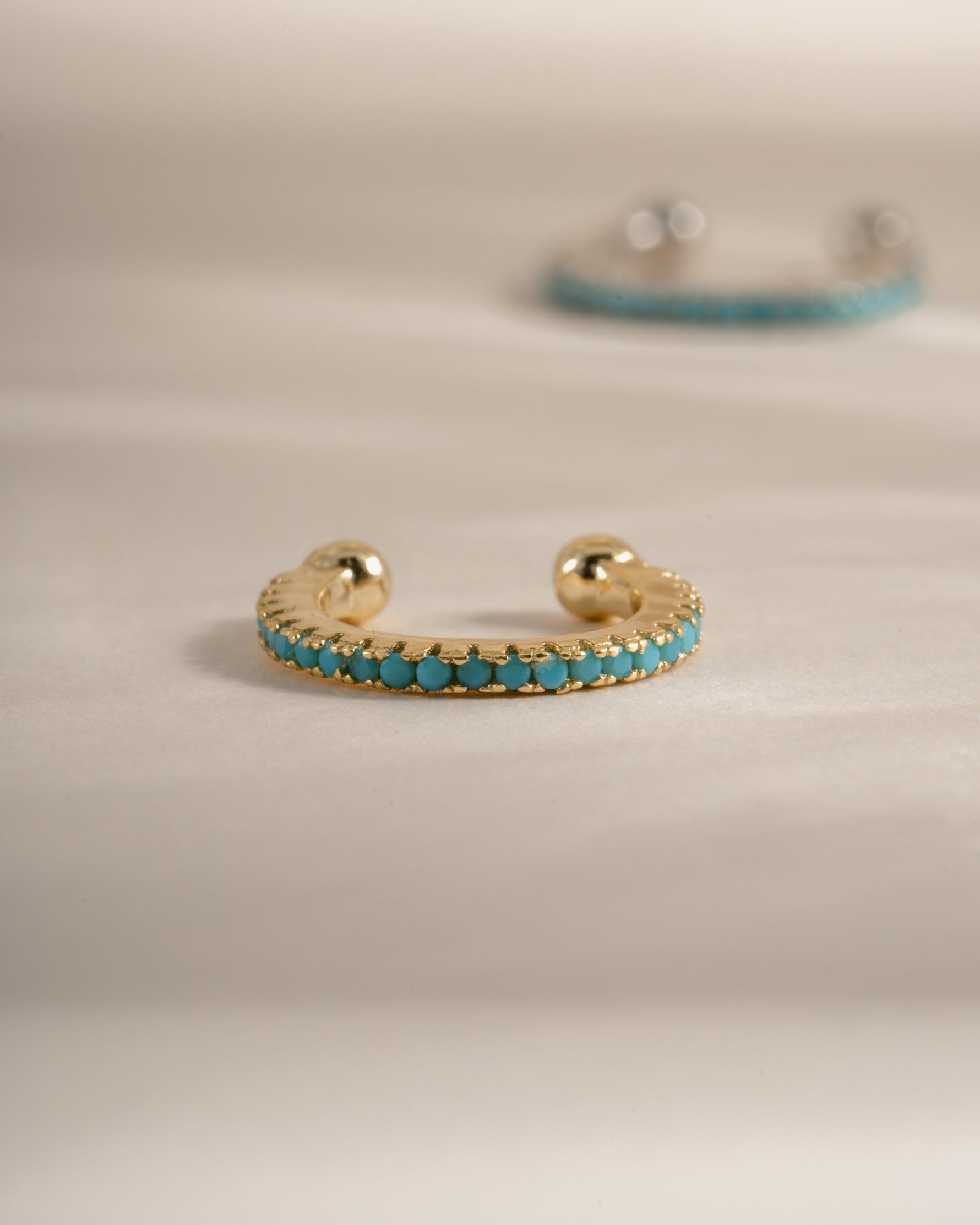 Gold turquoise ear cuff earrings by Sami Jewels, front view showing detailed turquoise stone and elegant design.