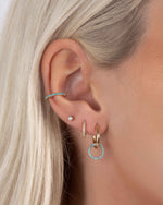 Gold turquoise ear cuff earrings by Sami Jewels worn on a model, showcasing stylish and modern jewelry design.