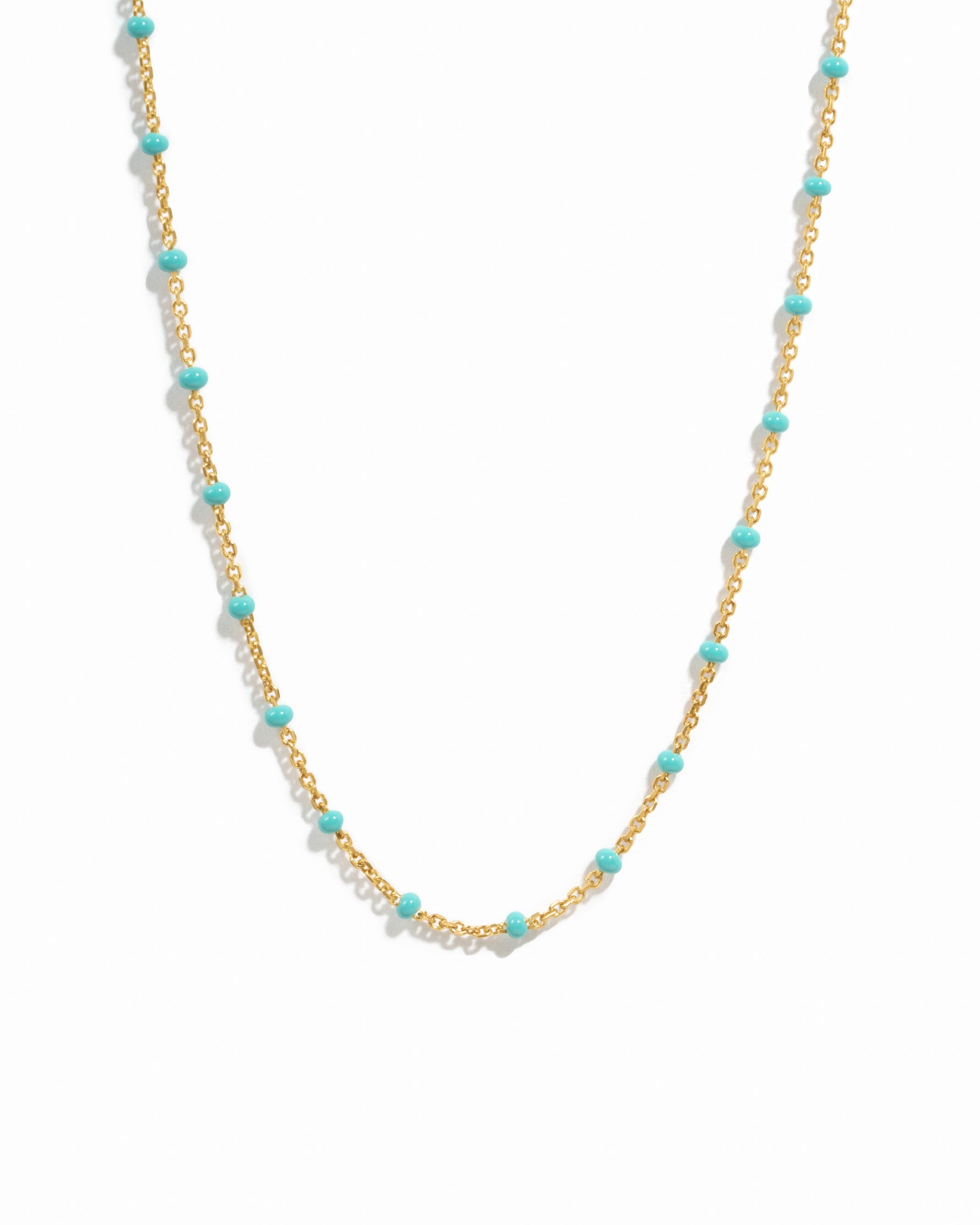 Turquoise enamel beaded necklace by Sami Jewels featuring vibrant blue beads on a gold chain.