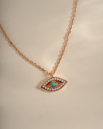 Close-up of Sami Jewels turquoise evil eye necklace with rose gold chain and detailed beadwork.