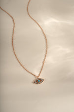 Turquoise evil eye necklace with rose gold chain from Sami Jewels, featuring a circular evil eye pendant with turquoise and gold accents.