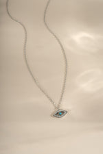 Turquoise evil eye necklace with sterling silver chain from Sami Jewels, featuring a vibrant turquoise pendant with evil eye design.