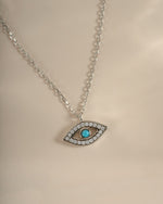 Turquoise evil eye necklace by Sami Jewels featuring a sterling silver chain and a vibrant turquoise evil eye pendant.