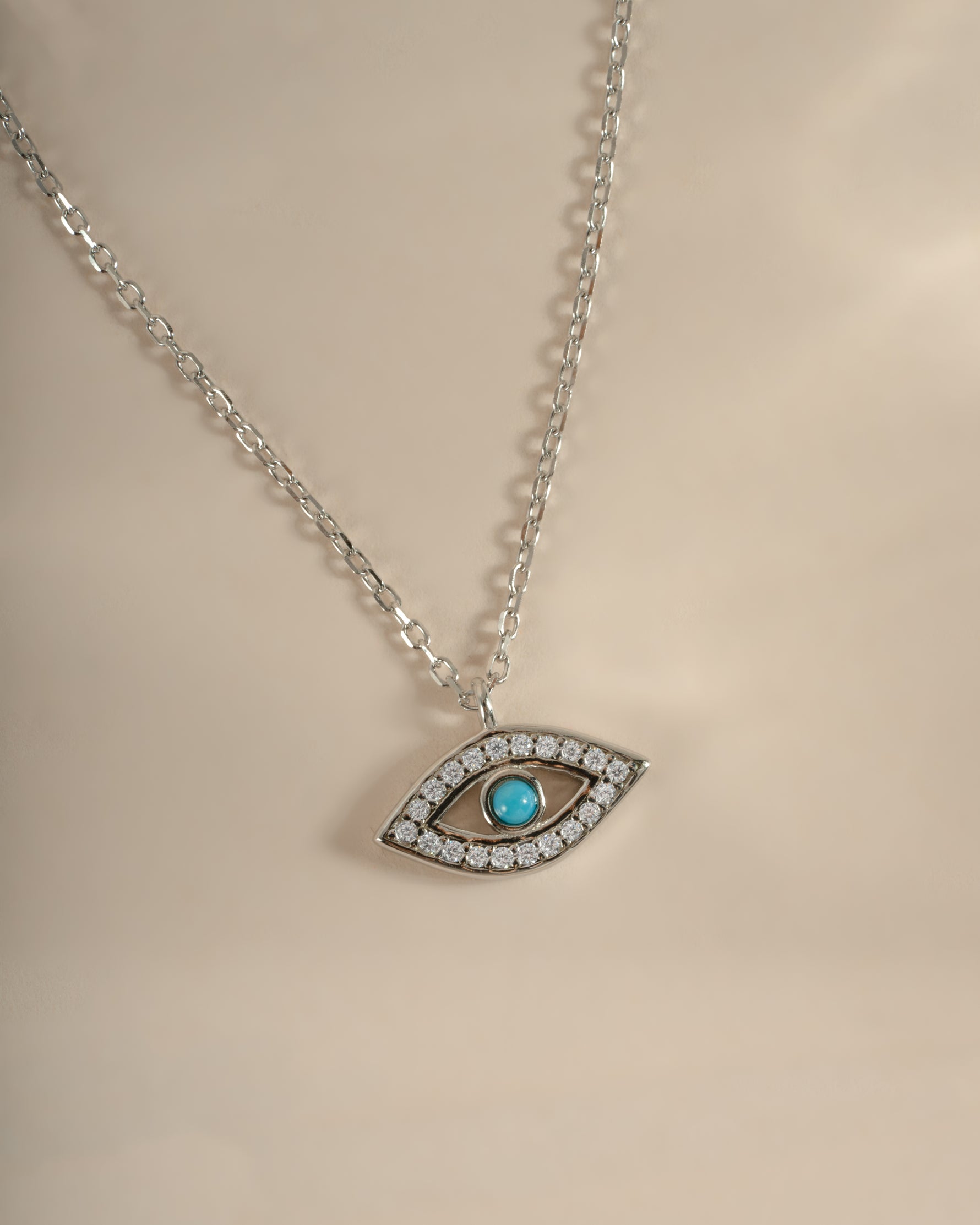 Turquoise evil eye necklace by Sami Jewels featuring a sterling silver chain and a vibrant turquoise evil eye pendant.