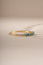 Side view of Sami Jewels 5 Stone Turquoise Ring showcasing gold band and vibrant turquoise stones.