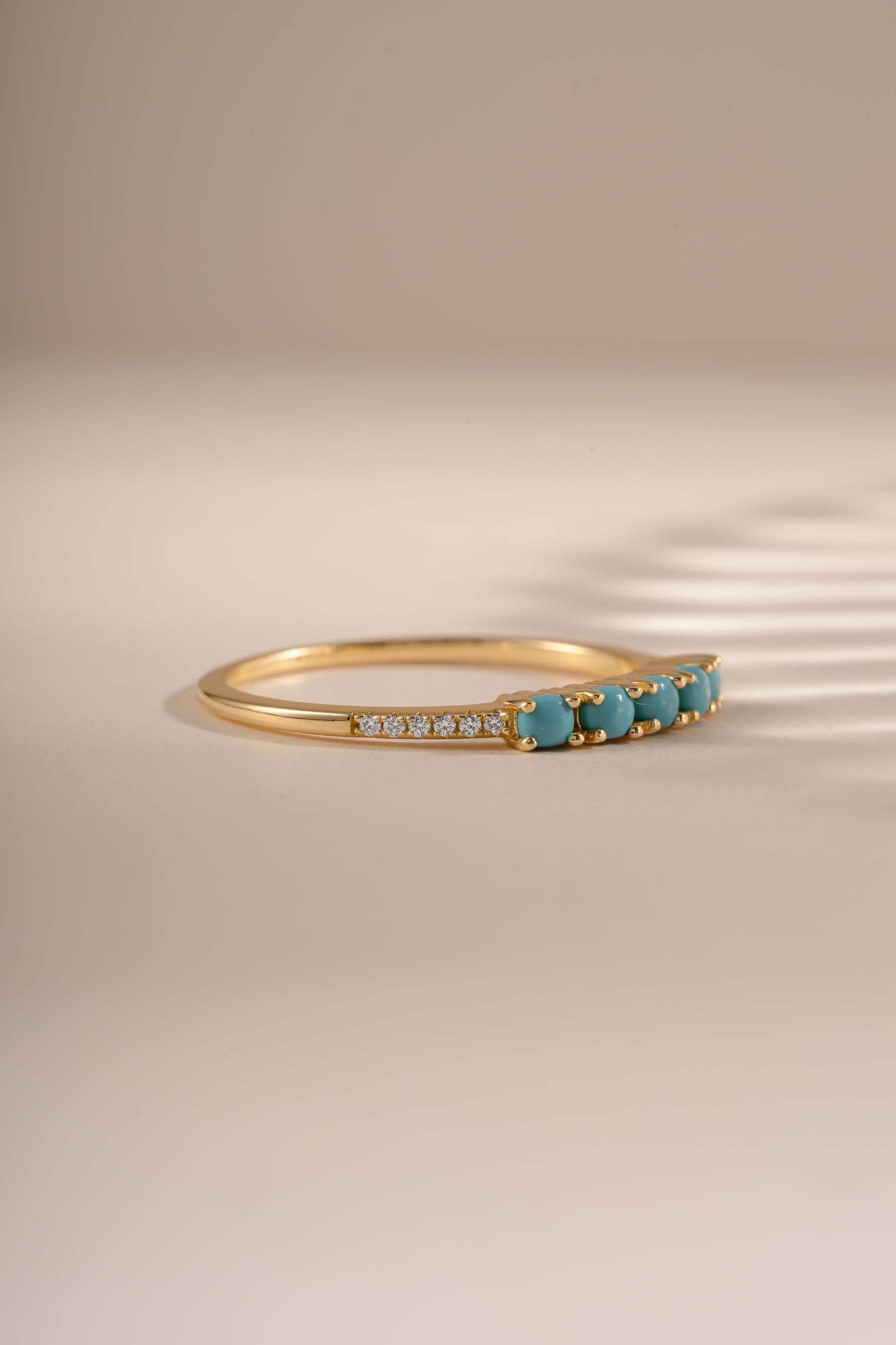 Side view of Sami Jewels 5 Stone Turquoise Ring showcasing gold band and vibrant turquoise stones.