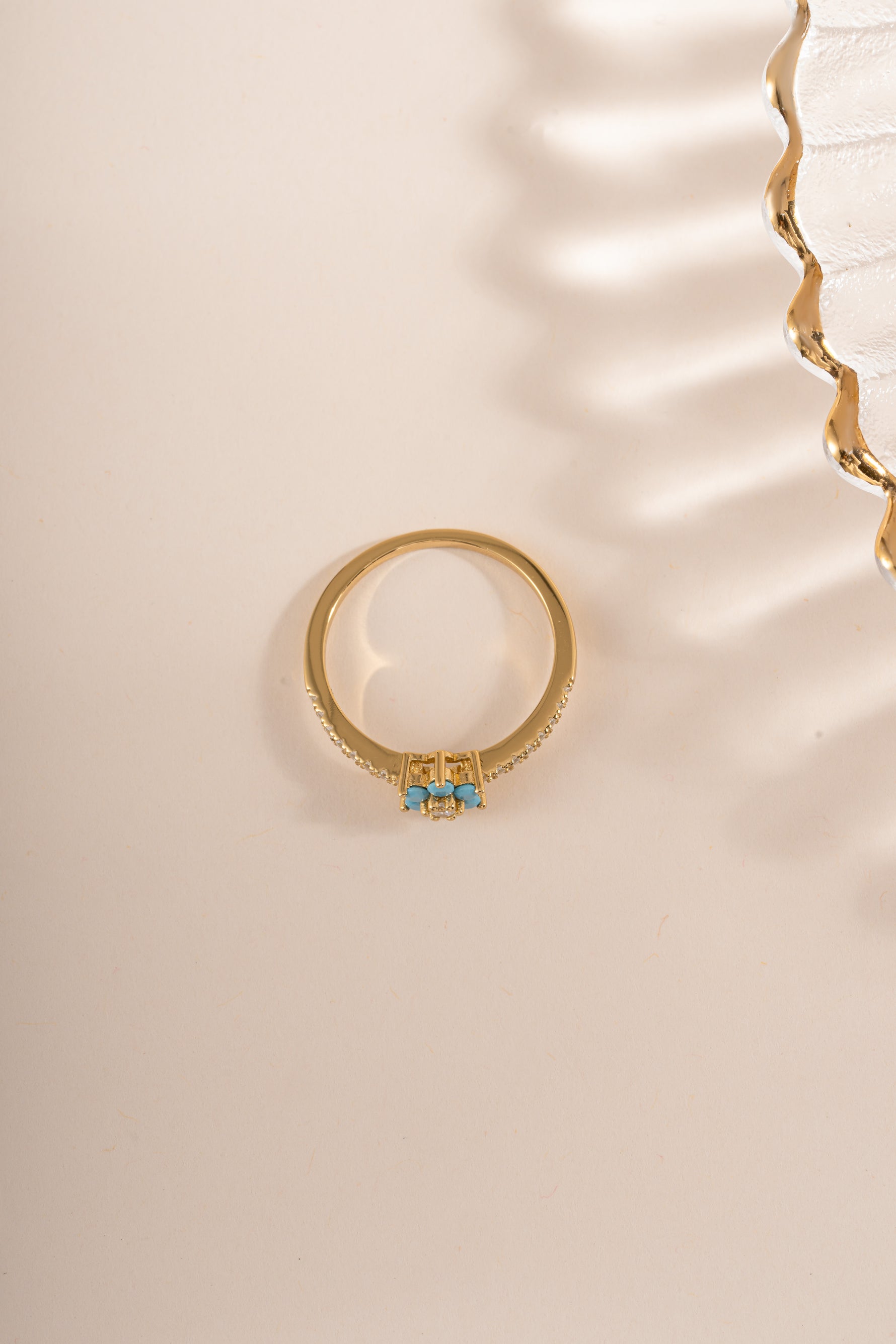 Gold-topped turquoise flower ring by Sami Jewels featuring a detailed floral design and vibrant turquoise gemstone.